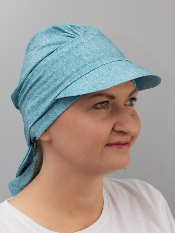 Breathable bamboo hat in melange colors featuring a cap peak for sun protection and a decorative band, perfect for chemo patients